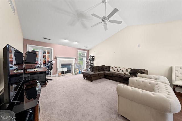 1446 Chesapeake Ave, Louisville, OH 44641 - living area with a ceiling fan, a glass covered fireplace, lofted ceiling, carpet flooring, and an office area