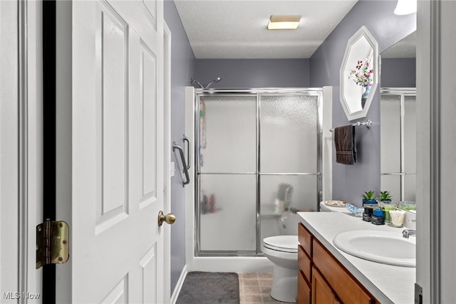 1446 Chesapeake Ave, Louisville, OH 44641 - full bathroom with vanity, a shower stall, tile patterned floors, and a textured ceiling