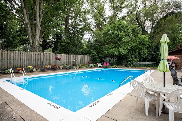 22936 Mastick Rd, Fairview Park, OH 44126 - community pool with a fenced backyard, view of wooded area, and a patio area