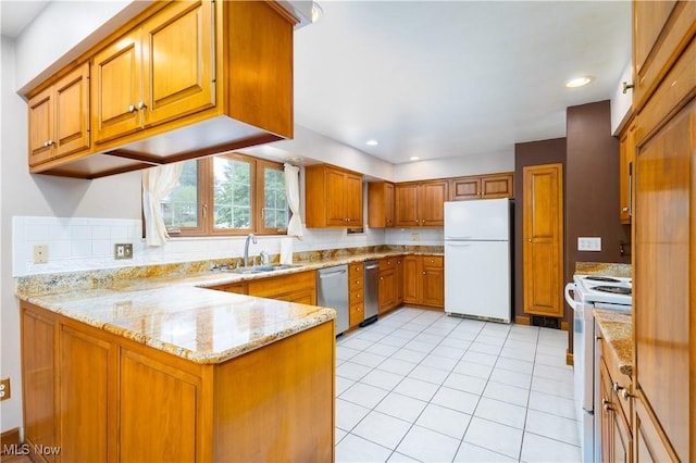 3945 Palisades Dr, Weirton, WV 26062 - kitchen with white appliances, brown cabinets, a peninsula, light stone counters, and light tile patterned floors