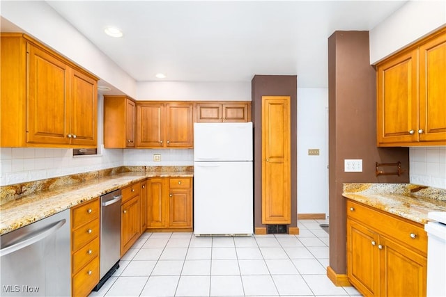 3945 Palisades Dr, Weirton, WV 26062 - kitchen with freestanding refrigerator, stainless steel dishwasher, brown cabinetry, light stone countertops, and recessed lighting