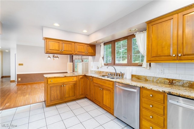 3945 Palisades Dr, Weirton, WV 26062 - kitchen featuring dishwasher, brown cabinetry, a peninsula, light stone countertops, and recessed lighting