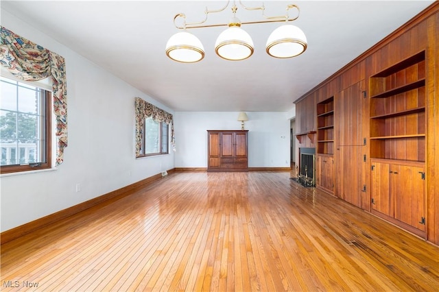3945 Palisades Dr, Weirton, WV 26062 - unfurnished living room with light wood-style flooring, a fireplace, and healthy amount of natural light
