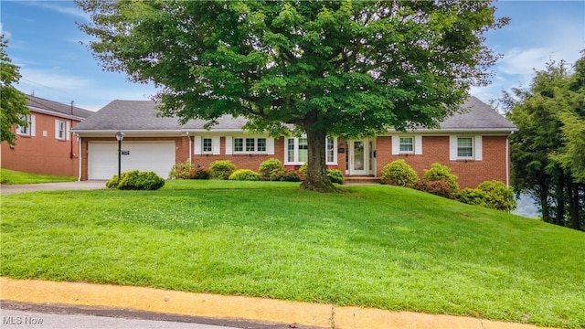 3945 Palisades Dr, Weirton, WV 26062 - ranch-style house featuring brick siding, an attached garage, a front lawn, and driveway