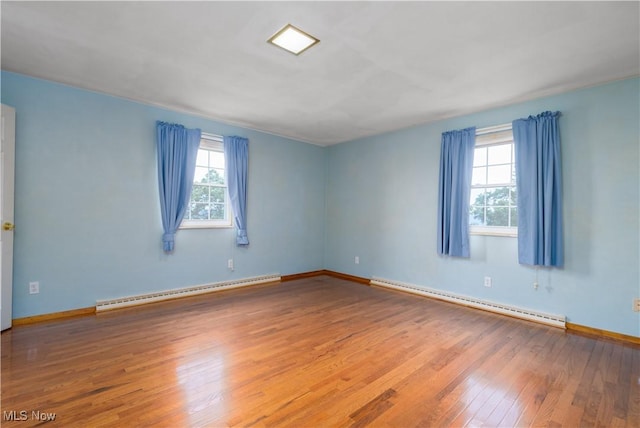 3945 Palisades Dr, Weirton, WV 26062 - empty room featuring baseboard heating and hardwood / wood-style floors