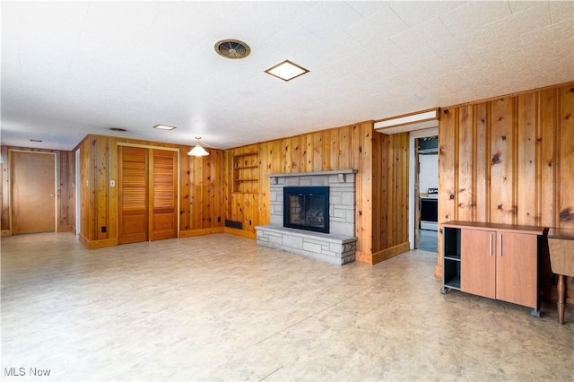 3945 Palisades Dr, Weirton, WV 26062 - unfurnished living room with wood walls and a stone fireplace