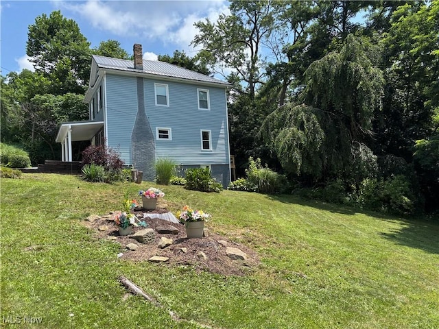 600 Marcus St, East Liverpool, OH 43920 - back of house featuring a chimney, a yard, and a metal roof