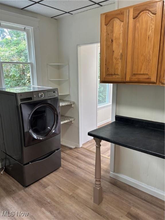 600 Marcus St, East Liverpool, OH 43920 - laundry area featuring washer / dryer, cabinet space, light wood-type flooring, and plenty of natural light