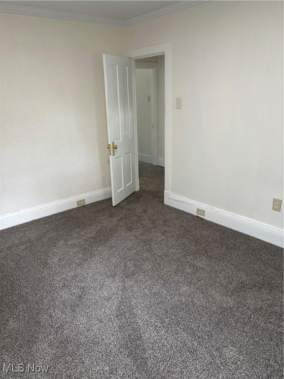600 Marcus St, East Liverpool, OH 43920 - unfurnished room featuring dark colored carpet and ornamental molding