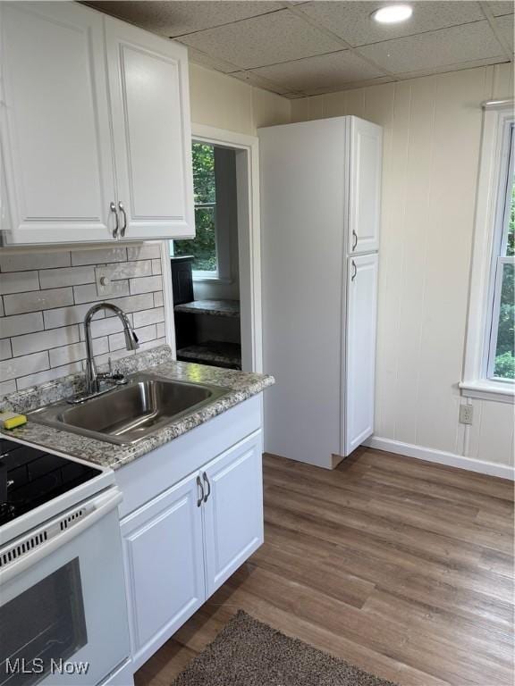 600 Marcus St, East Liverpool, OH 43920 - kitchen featuring white cabinetry, electric stove, dark wood-style flooring, plenty of natural light, and a drop ceiling