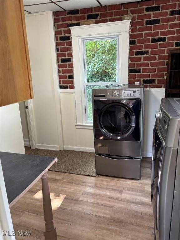 600 Marcus St, East Liverpool, OH 43920 - laundry room with washer and clothes dryer, light wood-style floors, and brick wall