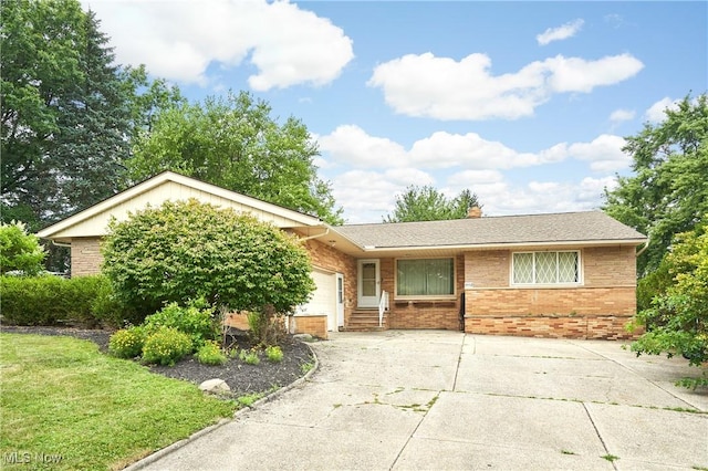 5552 Briarcliff Dr, Garfield Heights, OH 44125 - ranch-style house featuring brick siding, a garage, driveway, and a chimney