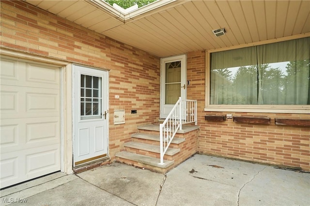 5552 Briarcliff Dr, Garfield Heights, OH 44125 - view of exterior entry with brick siding and a garage