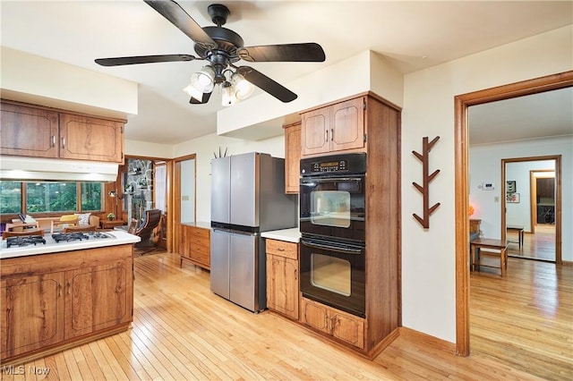 5552 Briarcliff Dr, Garfield Heights, OH 44125 - kitchen with freestanding refrigerator, under cabinet range hood, light wood-type flooring, and ceiling fan
