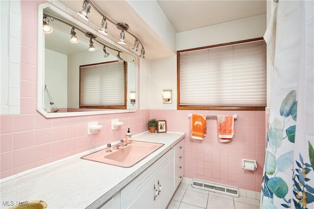 5552 Briarcliff Dr, Garfield Heights, OH 44125 - full bath featuring vanity, tile walls, tile patterned floors, and a wainscoted wall