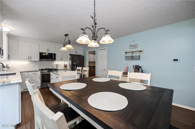 9034 Huxley Ln, Olmsted Twp, OH 44138 - dining area featuring dark wood-type flooring, a chandelier, and a textured ceiling