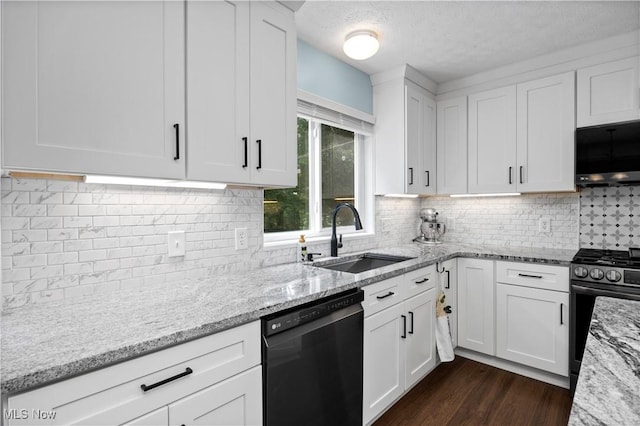 9034 Huxley Ln, Olmsted Twp, OH 44138 - kitchen with black dishwasher, stainless steel gas range, white cabinets, light stone countertops, and a textured ceiling