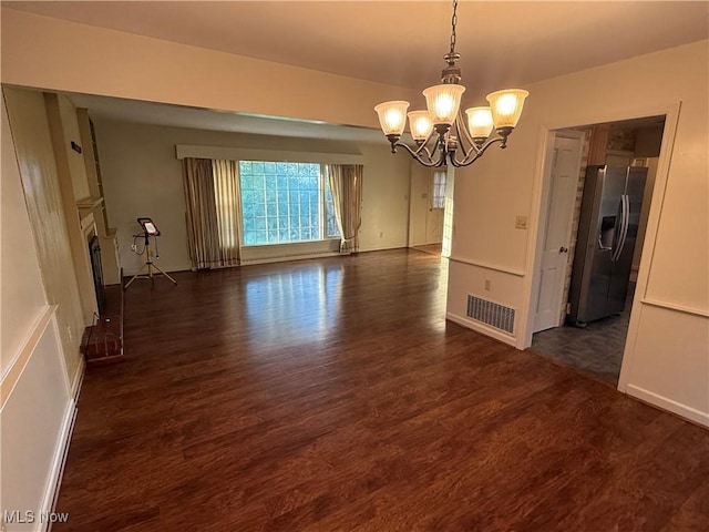 62239 Hillcrest Rd, Barnesville, OH 43713 - unfurnished dining area featuring a chandelier, wood finished floors, and a fireplace