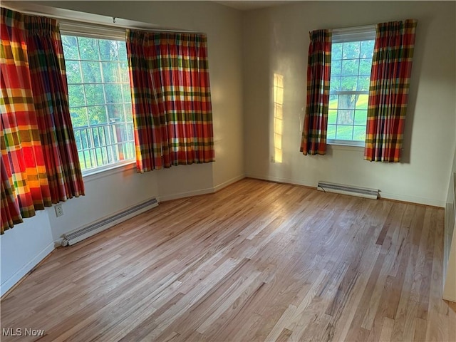 62239 Hillcrest Rd, Barnesville, OH 43713 - unfurnished room with baseboard heating, a baseboard heating unit, and wood finished floors