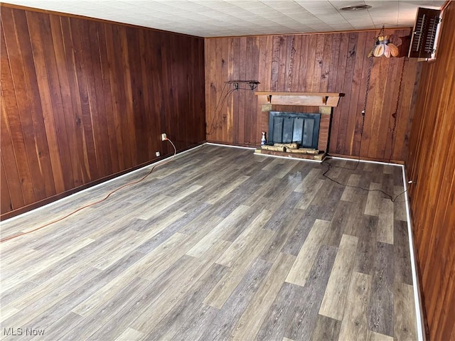 62239 Hillcrest Rd, Barnesville, OH 43713 - unfurnished living room with wood finished floors, a fireplace, and wood walls