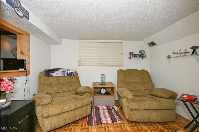 1266 Pitkin Ave, Akron, OH 44310 - sitting room with a textured ceiling and lofted ceiling
