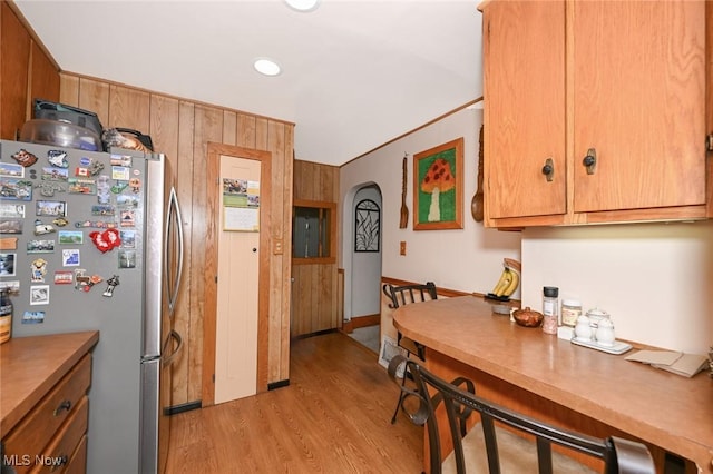 1266 Pitkin Ave, Akron, OH 44310 - kitchen featuring freestanding refrigerator, light wood-type flooring, arched walkways, recessed lighting, and brown cabinets