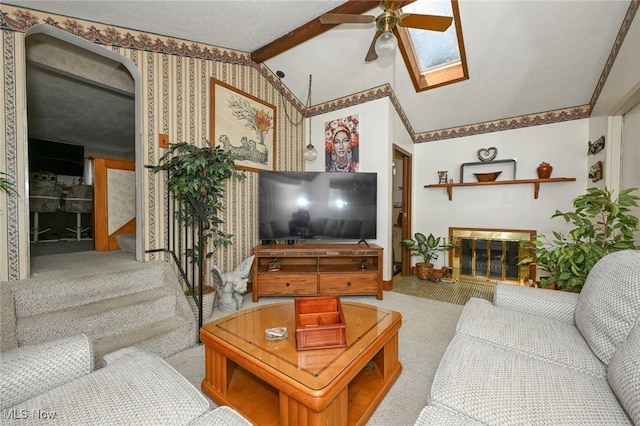1266 Pitkin Ave, Akron, OH 44310 - living room with lofted ceiling, a ceiling fan, carpet, a glass covered fireplace, and stairs