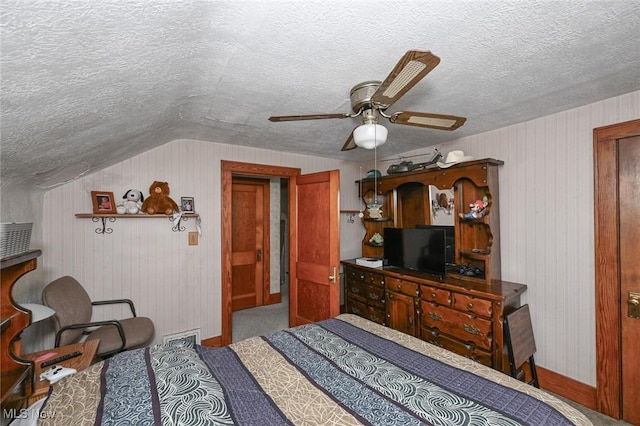 1266 Pitkin Ave, Akron, OH 44310 - bedroom featuring a textured ceiling, lofted ceiling, ceiling fan, and carpet flooring