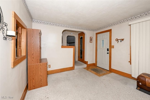 1266 Pitkin Ave, Akron, OH 44310 - carpeted entryway featuring a textured ceiling and arched walkways