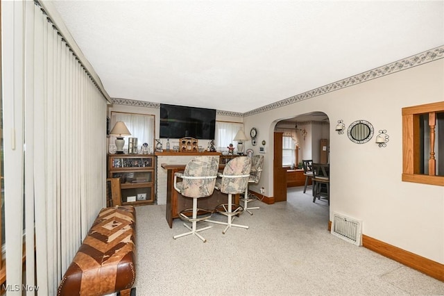 1266 Pitkin Ave, Akron, OH 44310 - carpeted dining space featuring arched walkways and baseboards