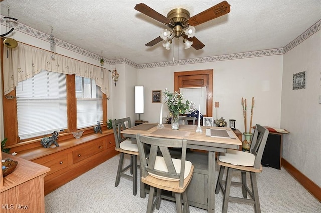 1266 Pitkin Ave, Akron, OH 44310 - dining area featuring ceiling fan, light colored carpet, and a textured ceiling