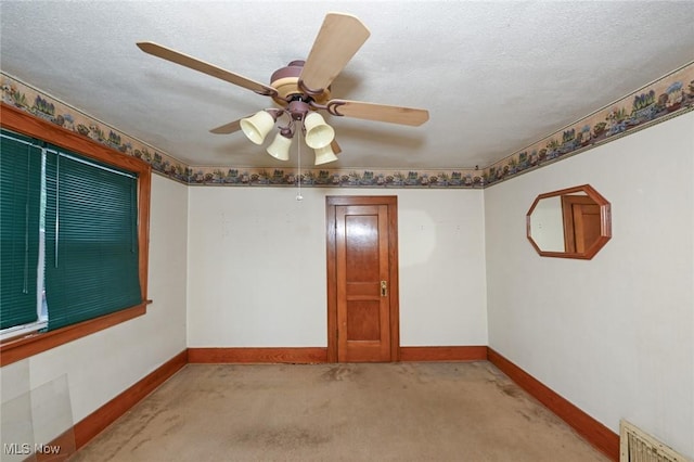 1266 Pitkin Ave, Akron, OH 44310 - spare room with light colored carpet, a ceiling fan, and a textured ceiling