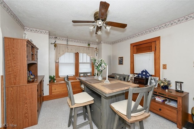 1266 Pitkin Ave, Akron, OH 44310 - dining area featuring ceiling fan, a textured ceiling, and light carpet