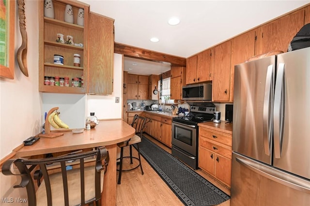 1266 Pitkin Ave, Akron, OH 44310 - kitchen with appliances with stainless steel finishes, light wood-type flooring, brown cabinets, and recessed lighting