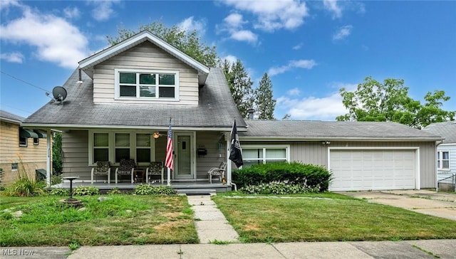 1266 Pitkin Ave, Akron, OH 44310 - view of front of home with covered porch, concrete driveway, an attached garage, and a front yard