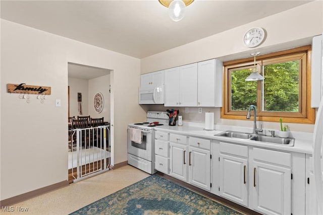 71050 Barries Dr, Martins Ferry, OH 43935 - kitchen featuring white appliances, white cabinets, light countertops, and decorative light fixtures