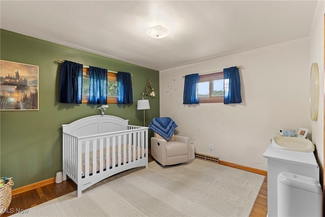 71050 Barries Dr, Martins Ferry, OH 43935 - bedroom with wood finished floors and a crib