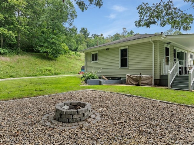 71050 Barries Dr, Martins Ferry, OH 43935 - back of property featuring a fire pit and a lawn