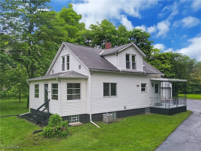 3187 Grenfall Rd, Norton, OH 44203 - rear view of property featuring a yard, a chimney, a shingled roof, and entry steps