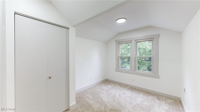 3187 Grenfall Rd, Norton, OH 44203 - unfurnished bedroom with vaulted ceiling, carpet flooring, and a closet