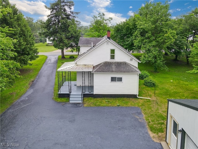 3187 Grenfall Rd, Norton, OH 44203 - view of front facade featuring a front yard, roof with shingles, and view of scattered trees