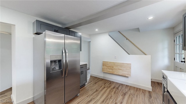 3187 Grenfall Rd, Norton, OH 44203 - kitchen with stainless steel refrigerator with ice dispenser, light countertops, light wood finished floors, and recessed lighting