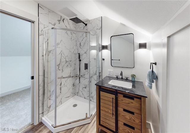 3187 Grenfall Rd, Norton, OH 44203 - full bath with a marble finish shower, lofted ceiling, vanity, and wood finished floors