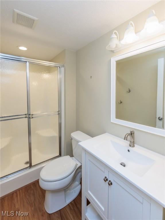 2271 Augusta Ct, Westlake, OH 44145 - full bathroom featuring vanity, a shower stall, wood finished floors, and recessed lighting
