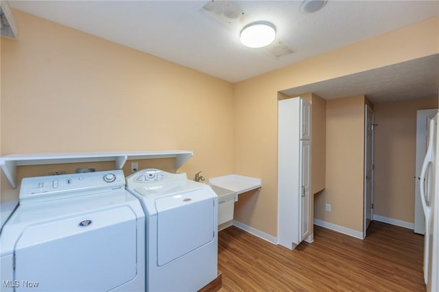 2271 Augusta Ct, Westlake, OH 44145 - laundry room with washing machine and dryer and wood finished floors