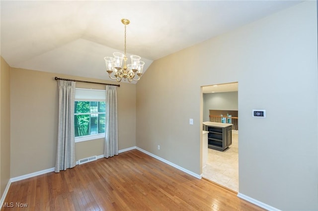 2271 Augusta Ct, Westlake, OH 44145 - spare room featuring light wood-style floors, lofted ceiling, and a chandelier