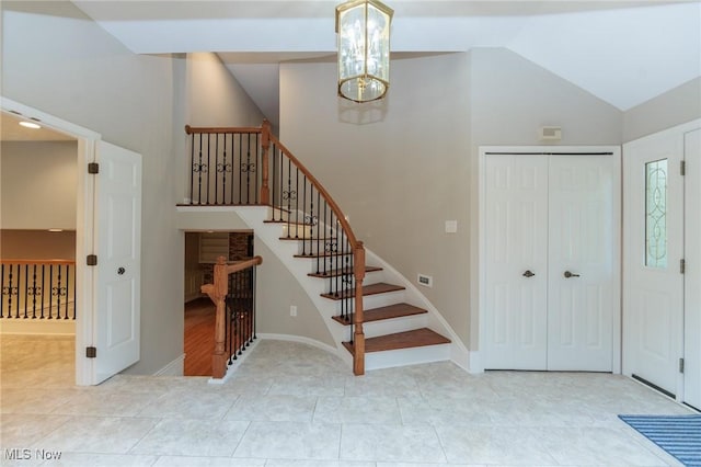 2271 Augusta Ct, Westlake, OH 44145 - stairs featuring tile patterned flooring, high vaulted ceiling, and a chandelier