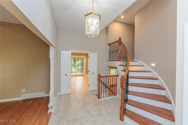 2271 Augusta Ct, Westlake, OH 44145 - entryway with a chandelier, a high ceiling, and stairway