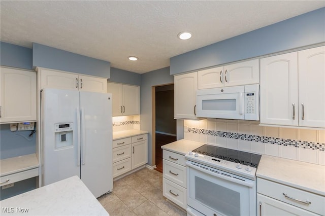 2271 Augusta Ct, Westlake, OH 44145 - kitchen featuring white appliances, light countertops, backsplash, white cabinets, and light tile patterned flooring