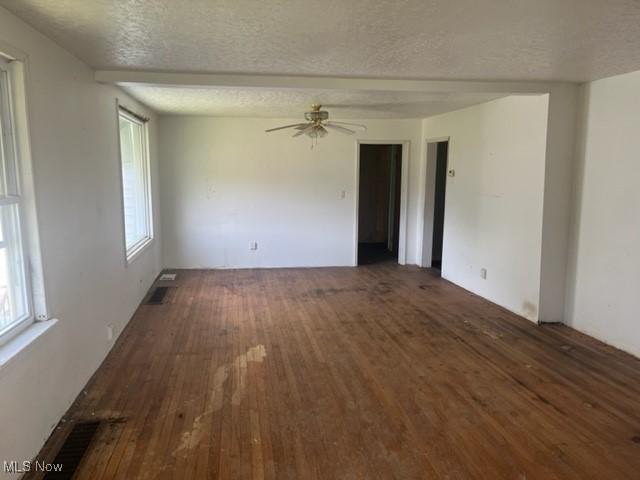 70610 Chermont Rd, Bridgeport, OH 43912 - empty room featuring wood-type flooring, a textured ceiling, and a ceiling fan